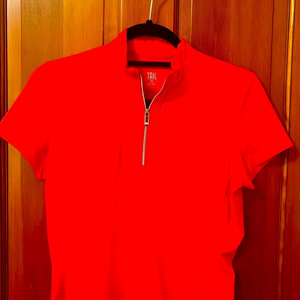 Womens golf shirt by Tail. Zip front